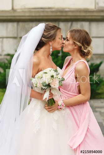 Bride And Bridesmaid Kissing At Wedding Day Happy