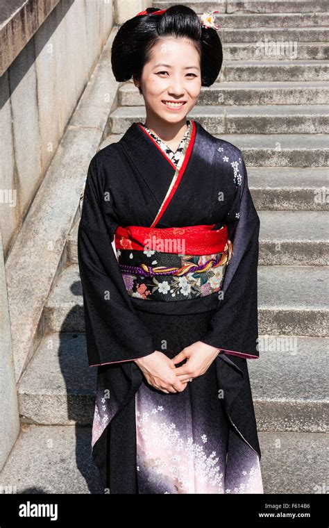 Japan Kyoto Mature Woman In Black Kimono With Red Obi Sash Standing