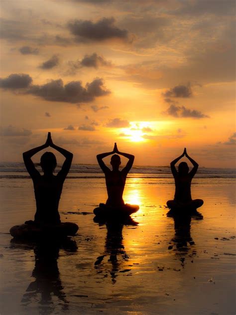 people sitting   beach  yoga exercises  sunset   arms   air
