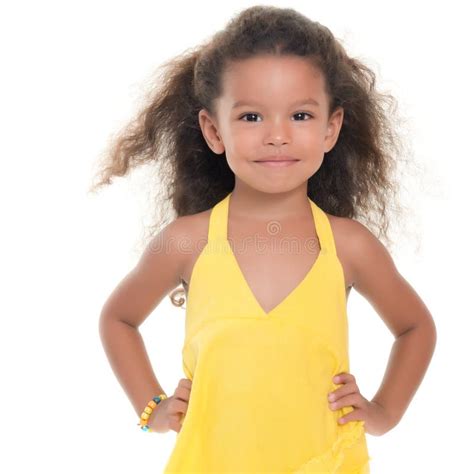 cute small african american hispanic girl wearing yellow summer dress