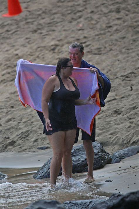 the awesome pierce brosnan wrapping his wife in a towel after a swim love that she s not a