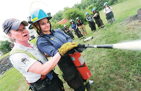 lieutenant lyn moraghan left instructs tara sivak in the use of a fire extinguisher during a