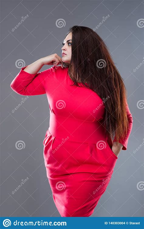 brunette plus size fashion model in red dress fat woman with long hair