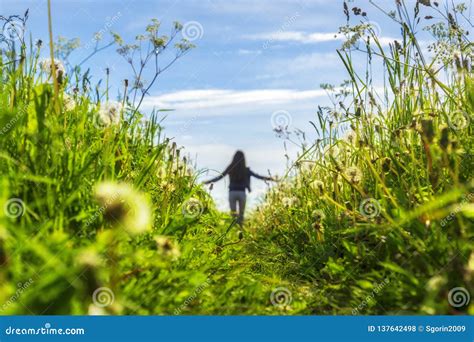 Girl Is Walking On Flowering Meadow Enjoying Peaceful Nature Stock