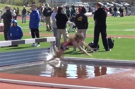 running athlete falls over hurdle during steeplechase race