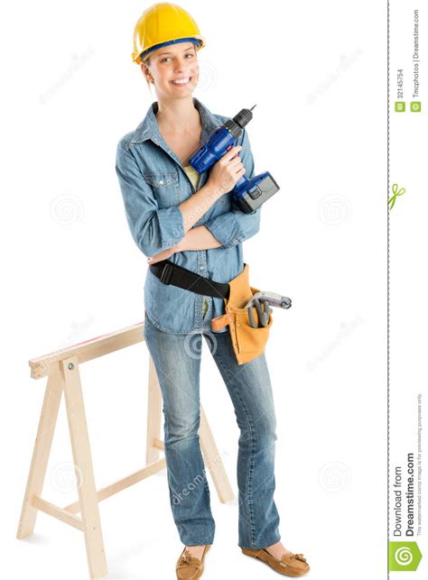 female construction worker with drill standing by work