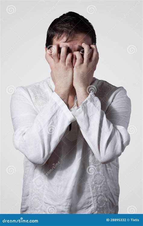 young man hiding  face  hands stock photo image  frantic