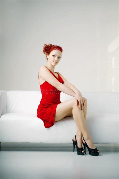 Redhead Woman In A Red Dress On White Couch Stock Image Image Of