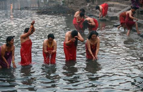 Nepalese Hindu Devotees Bathe In The Bagmati River At The Pashupatinath