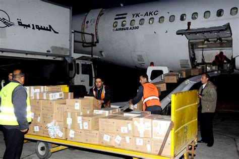 workers offload humanitarian aid donated by russia at