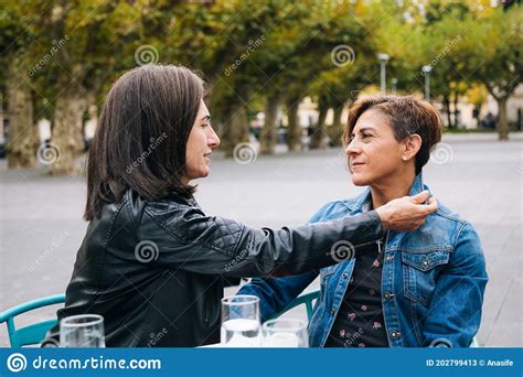 middle aged lesbian couple taking care of each other stock image