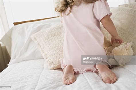 usa california los angeles girl playing with teddy bear in bed photo