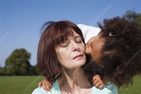 Girl Kissing Grandmother Outdoors Stock Image F006 6253 Science