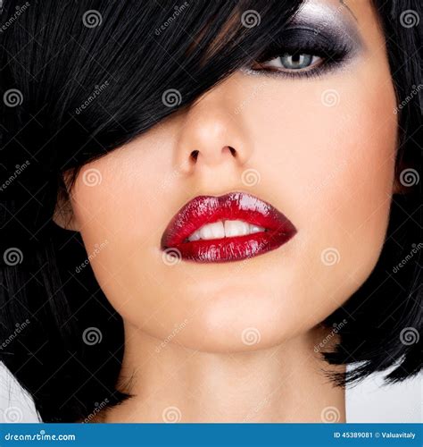 beautiful brunette woman with shot hairstyle and red lips stock image