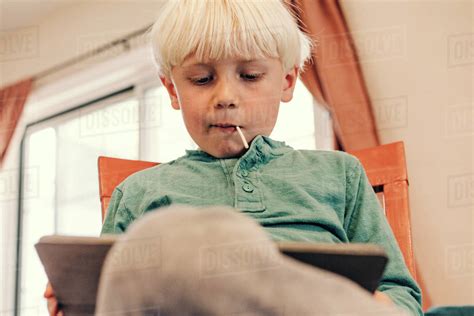 young boy  school work  tablet stock photo dissolve