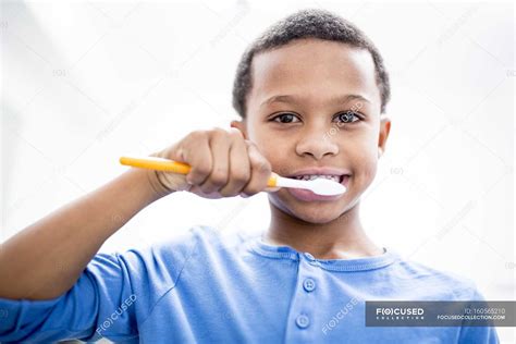 portrait  boy brushing teeth  white background medicine people