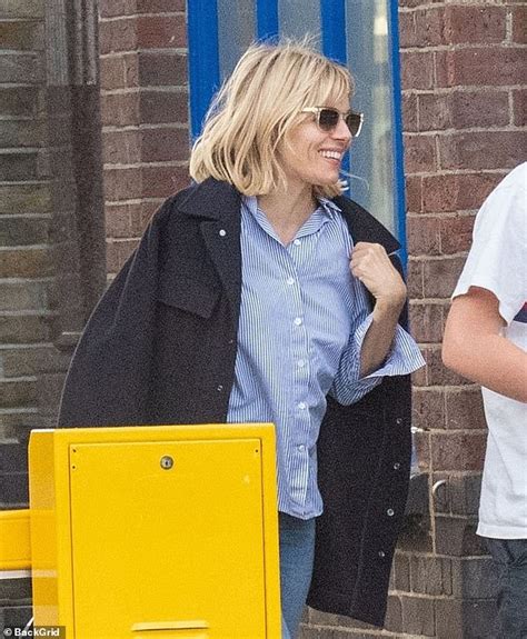 sienna miller has lots to smile about as she returns home from new york