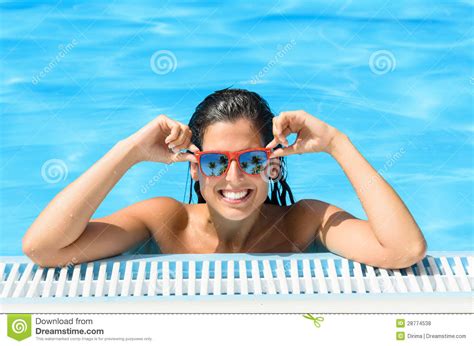 happy woman enjoying pool in tropical resort on summer