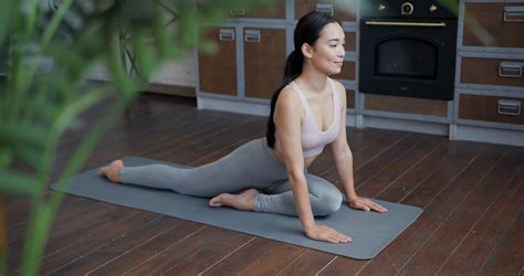 healthy asian yoga woman practicing stretching pose  home
