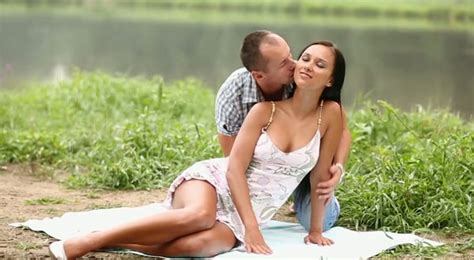 romantic couple having sensual sex near the lake video