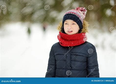 Cute Young Girl Having Fun On A Walk In Snow Covered Pine Forest On