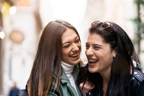 lesbian couple laughing together by stocksy contributor santi nuñez