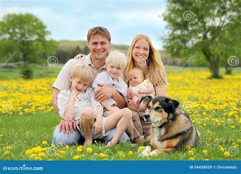 happy family  pet dog  flower meadow stock photo image