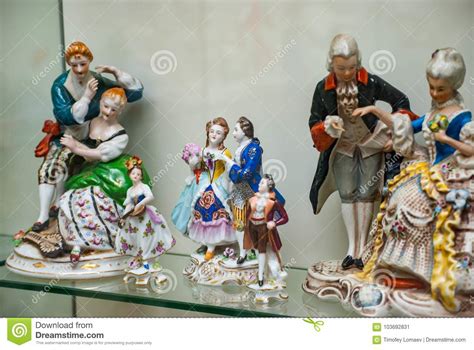 assortment  rare porcelain figurines  glass shelf stock image