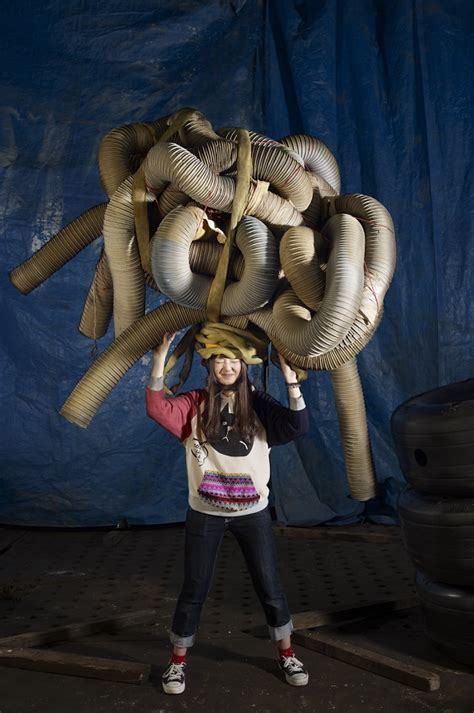 remarkable portraits of people around the world carrying symbolic objects on their heads