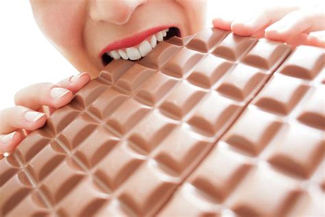 Woman Eating Chocolate Photograph By Ian Hooton Science Photo Library