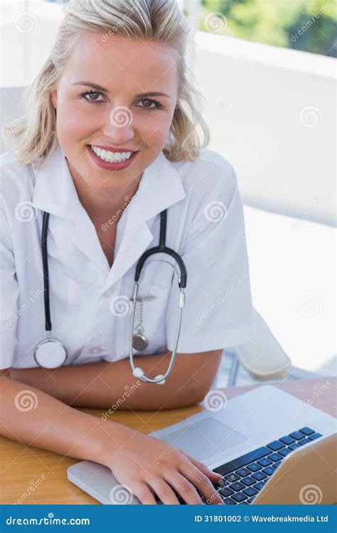 pretty nurse smiling    laptop stock photo cartoondealer
