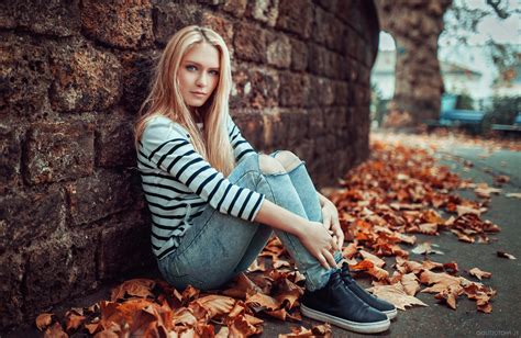 women blonde sitting looking at viewer pants jeans torn jeans