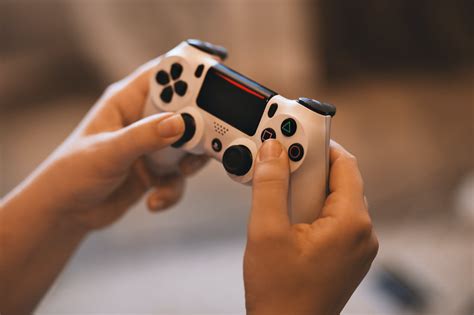 person holding sony ps controller  stock photo