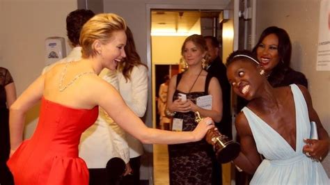 see jennifer lawrence attempt to playfully wrestle away lupita nyong