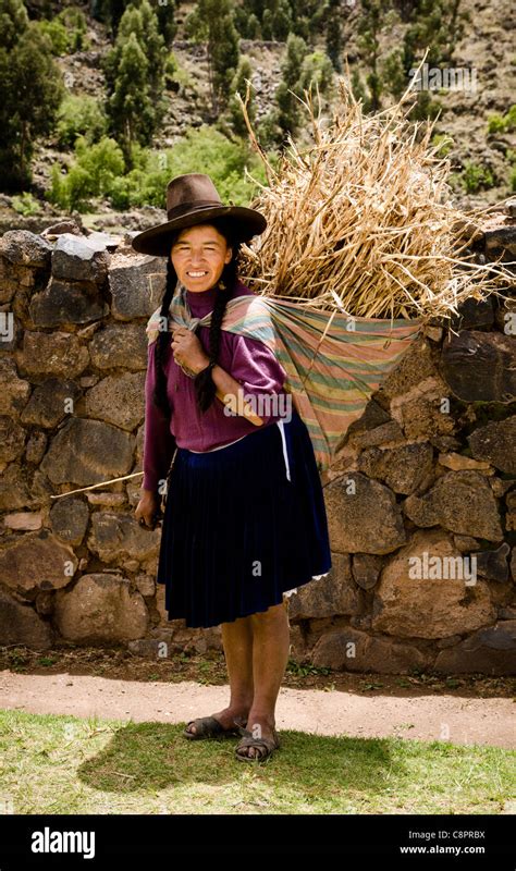 young peruvian woman carrying  straw bail puno peru stock photo alamy