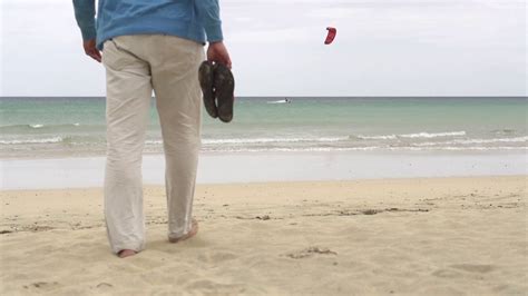 young man walking   beach slow motion shot  fps stock video