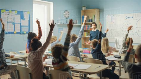 caring teacher explains lesson   classroom full  bright diverse