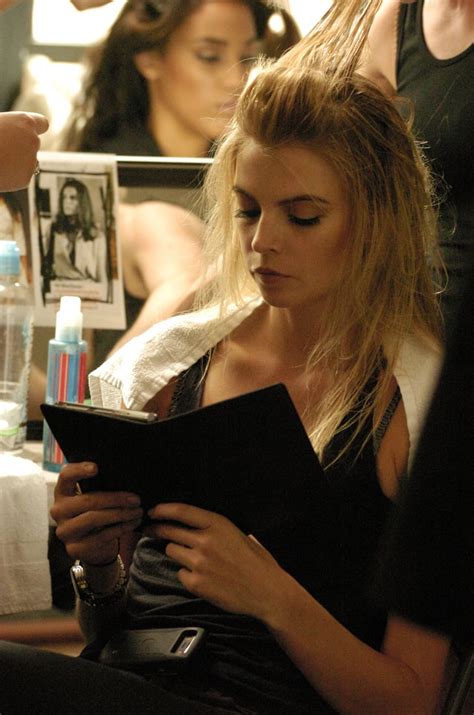a model focused on her kindle book while prepping for trina turk s models reading books