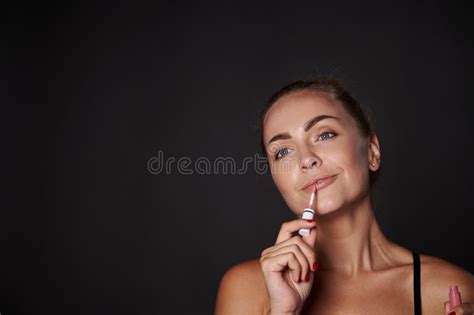 Beautiful Woman Applying Lip Gloss On Her Lips Attractive Blonde Woman