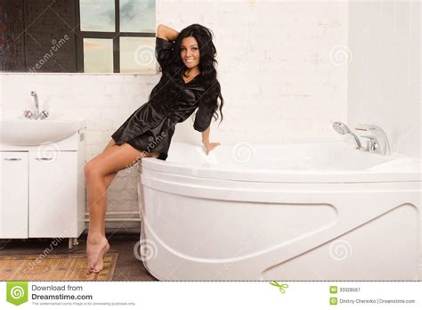 Beautiful Brunette Woman In The Bathroom Royalty Free