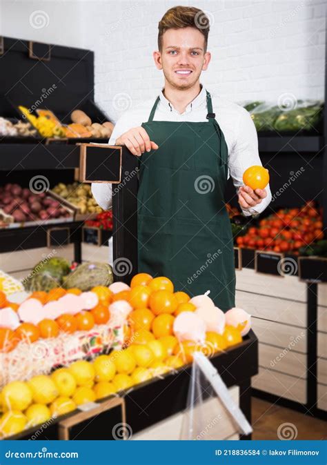 smiling male seller showing assortment stock photo image  organic