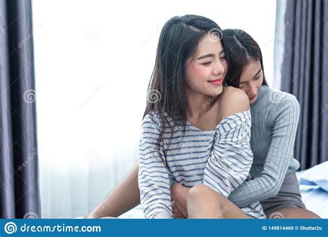 two asian lesbian women hug and embracing together in