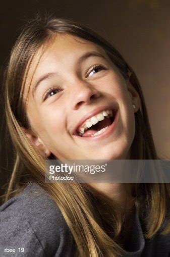 Caucasian Preteen Girl With Long Brown Hair Leans Her Head Back Looks