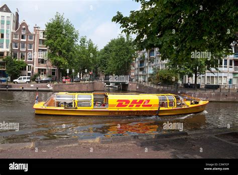 dhl boat   canal  amsterdam netherlands stock photo alamy