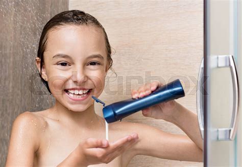 girl bathing under shower stock image colourbox