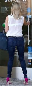 reese witherspoon displays her slim frame in high waisted jeans as she
