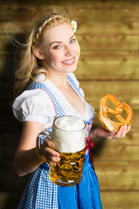 beautiful woman in a traditional bavarian dirndl with beer
