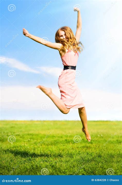 happy jumping girl stock photo image  field blue landscape