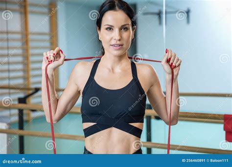 Attractive And Fit Brunette Stretching With Resistance Bands Stock