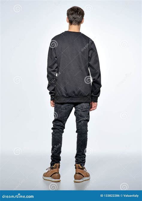 view teen boy stands  studio stock photo image  jeans